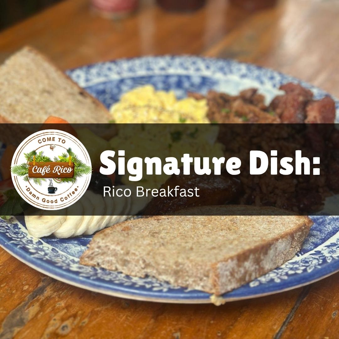 Rico Breakfast signature dish at Café Rico, known for the best breakfast in Puerto Viejo Costa Rica, with scrambled eggs, ham, pinto beans, grilled plantains, toast, and fresh local fruit served in a jungle café setting